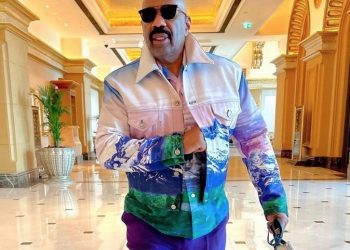 Steve Harvey Steps in Abu Dhabi Styled in a Louis Vuitton x Virgil Abloh Purple and Green Landscape Jacket and Matching Shirt