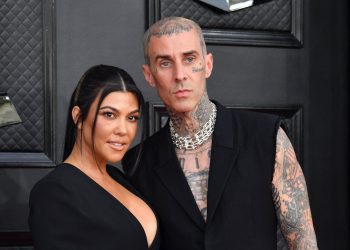 Kourtney Kardashian and musician Travis Barker arrive for the 64th Annual Grammy Awards at the MGM Grand Garden Arena in Las Vegas on April 3, 2022. (Photo by ANGELA  WEISS / AFP) (Photo by ANGELA  WEISS/AFP via Getty Images)