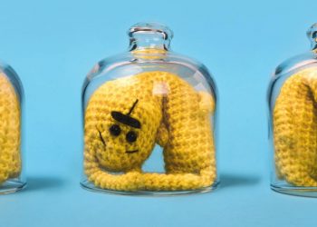 A picture of three figures trapped in a glass small space.