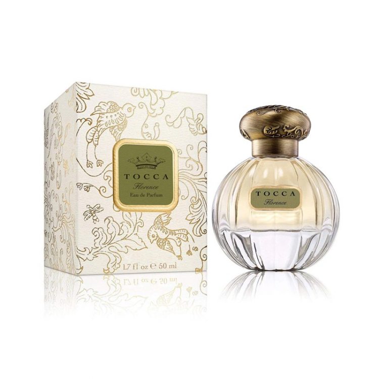 Tocca Florence Eau de Parfum small round bottle of pale gold perfume and round bronze cap and gold detailed box on white background
