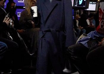 Image may contain Clothing Apparel Human Person Helmet Shoe Footwear Coat Overcoat Screen Electronics and Monitor