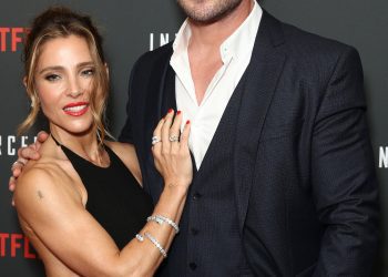 Image may contain Human Person Clothing Suit Overcoat Apparel Coat Elsa Pataky Chris Hemsworth and Fashion