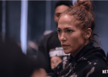 J.Lo wearing a sweatshirt in a messy bun