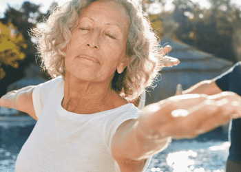mature woman with eyes closed in yoga pose