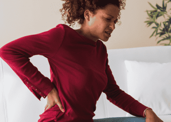 Woman holding back experiencing SI joint pain
