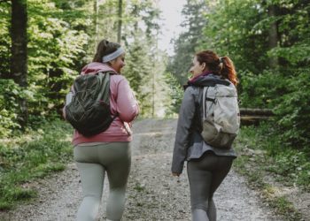Two women hiking with backpacks