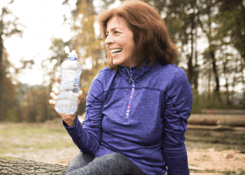 50 year old woman in running clothes outside