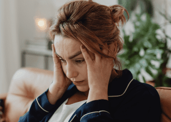 woman in her 40s sad on the couch