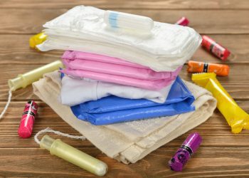 Photo of tampons, pads, and menstrual hygiene products on floor