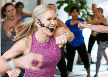 chris freytag in purple workout tank leading a workout