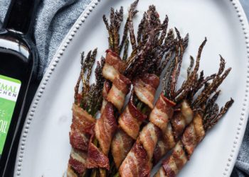 Bacon wrapped asparagus on white plate