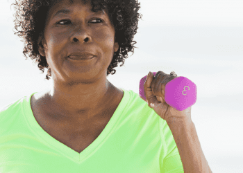 Middle aged woman holding a dumbbell for exercise equipment