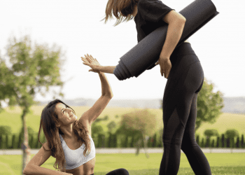 two woman high fiving after yoga