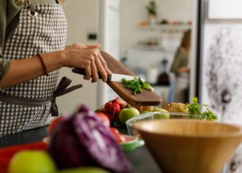 Woman cutting fruit and vegetables