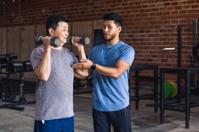 Health coach helps man with weights
