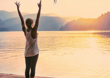 woman doing a sun salutation outside