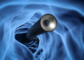 A 3-D rendering of a lit, flexible endoscope inside a curve of the colon; background is hazy blue, white, and black