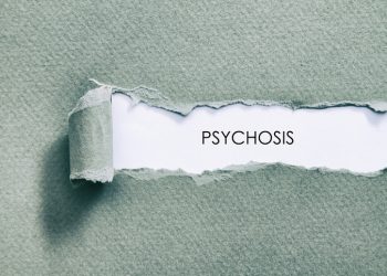 The word "psychosis" revealed under a peeled patch of blue-green textured paper