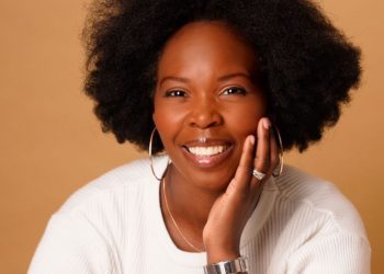 headshot of Beauté Insolente founder Stéphanie Guittonneau wearing a white sweater and silver jewelry sitting with her...