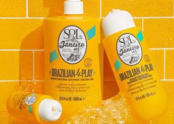 Three differentsized bottles of Sol de Janeiro Brazilian 4Play Moisturizing Shower CreamGel with sudsy bubbles leaning...